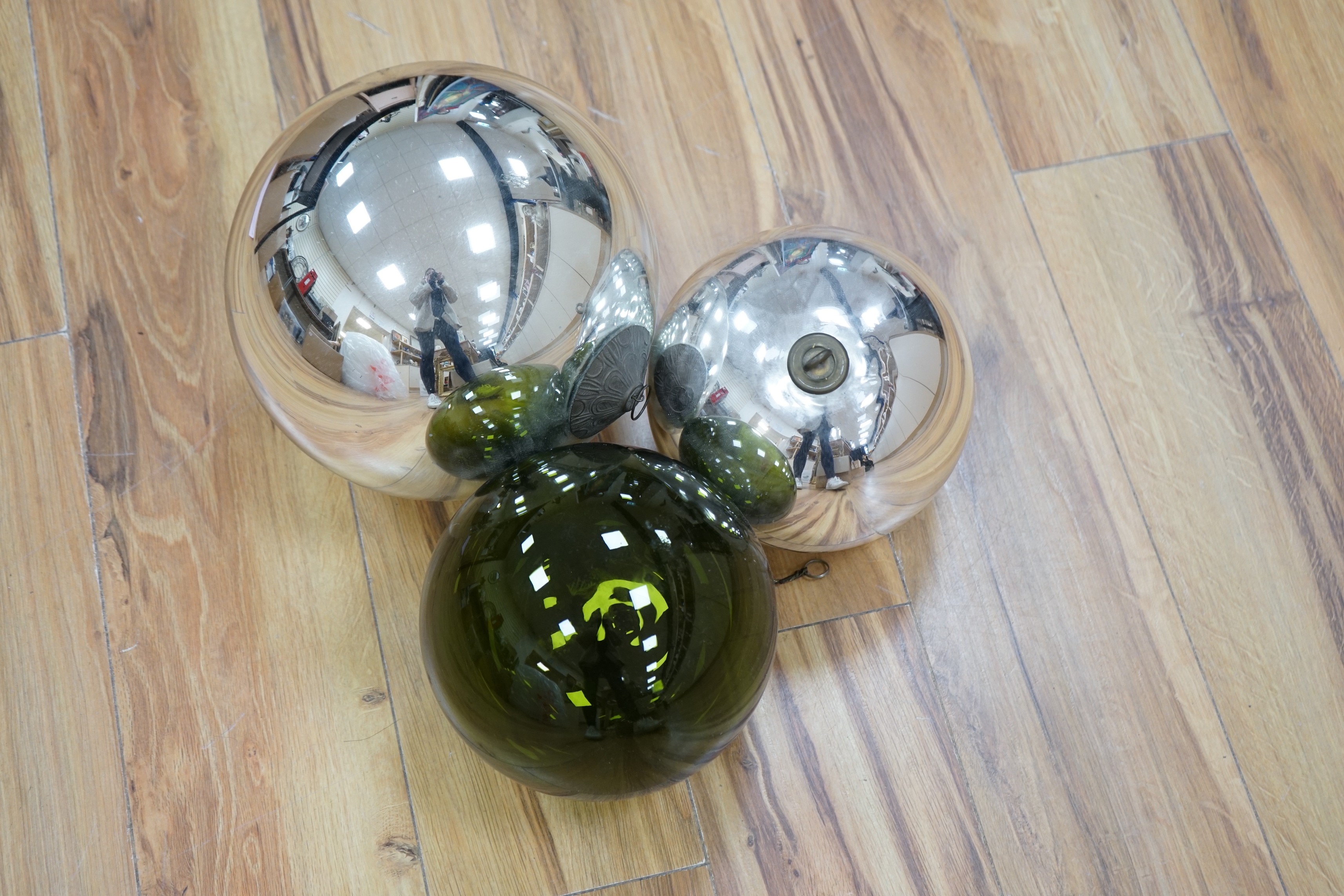 Two silvered glass witches balls and another